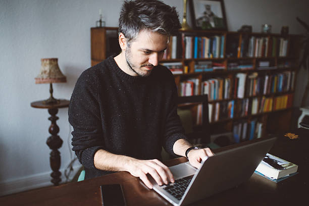 istock Young man doing a freelance job from home 638695268