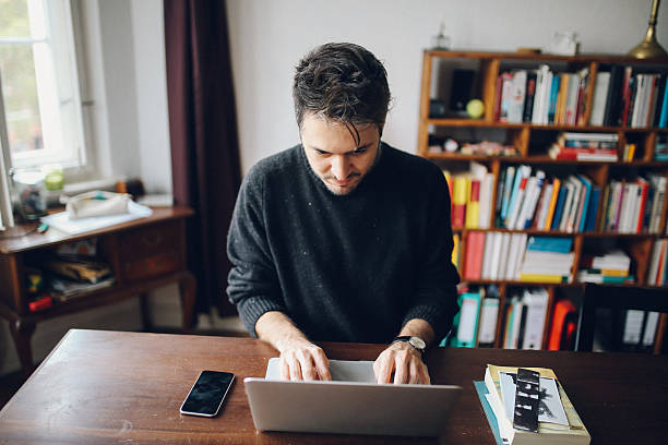 istock Young man doing a freelance job from home 638695470