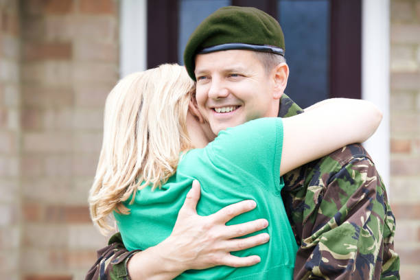 istock Army Husband Home On Leave Hugging Wife 638695840
