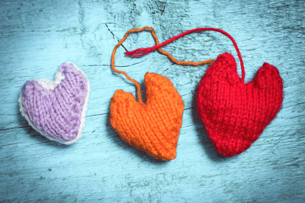 istock Colorful knitted hearts on the light blue boards 638696066