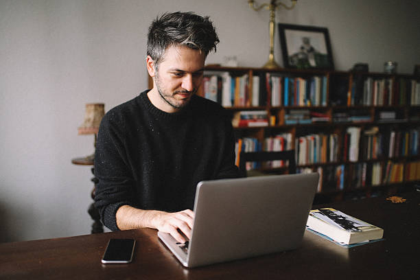 istock Young man doing a freelance job from home 638696806