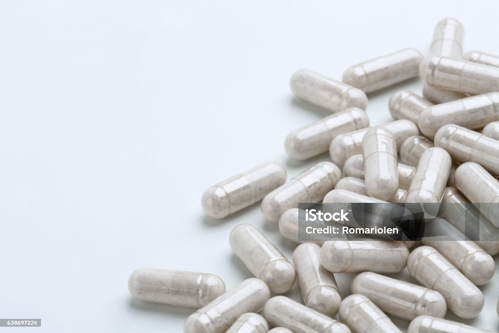 Heap of white capsules medications on white background Heap of white capsules medications on white background. Copy space. High resolution product. Health care concept Probiotic Stock Photo