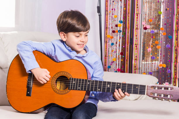 istock Little boy is playing the guitar 638699716