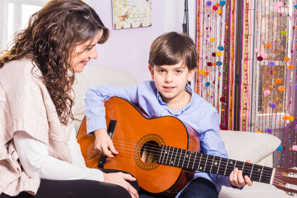 istock Mother and son playing guitar together 638699930