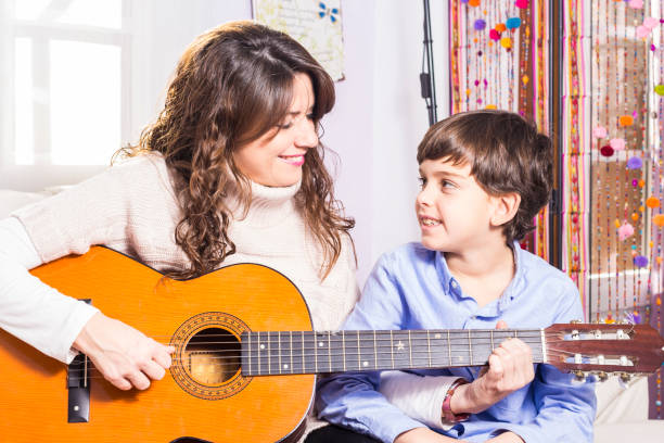 istock Mother and son playing guitar together 638700058