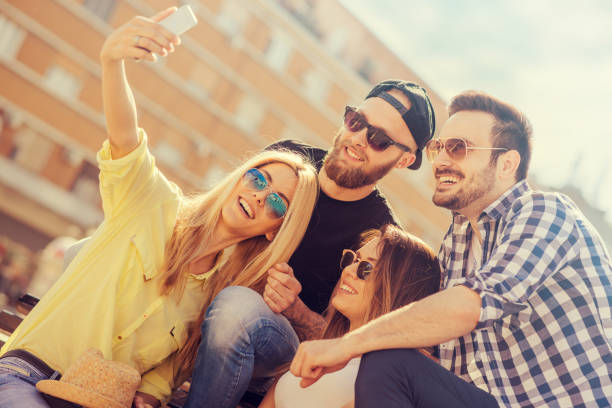 istock Group of four happy friends taking selfie 638700802