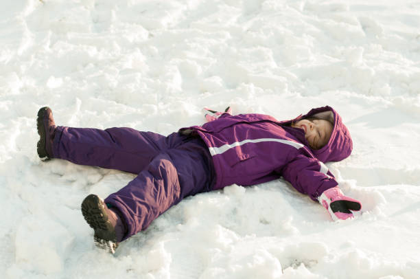 istock Girl lying on snow 638701014
