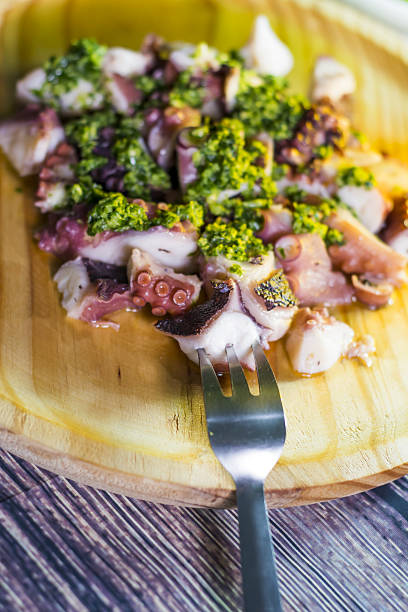 istock Octopus with paprika and sauce on a wooden table 638702030