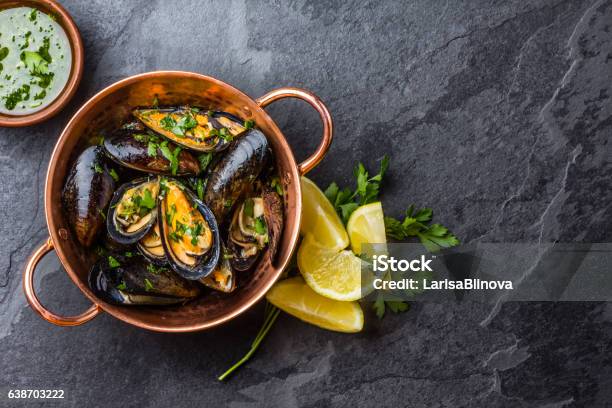 Mussels In Copper Bowl Lemon Herbs Sauce And White Wine Stock Photo - Download Image Now