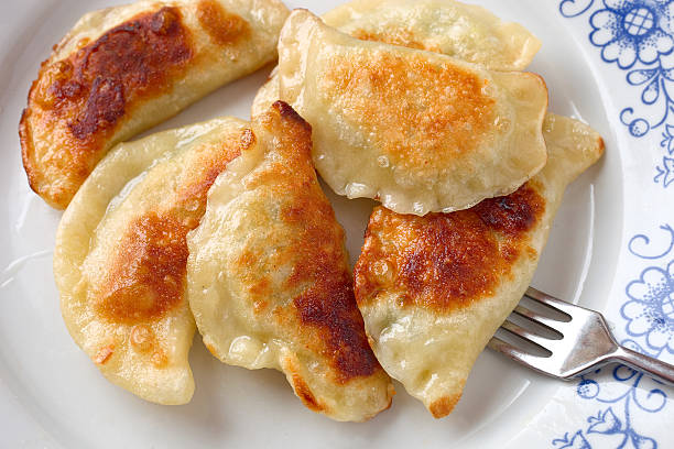 Dumplings Pierogi, or boiled filled dumplings, traditional Polish dish. pierogi stock pictures, royalty-free photos & images