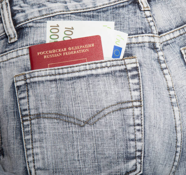 passport of the Russia and euros in a hip-pocket the passport of the citizen of Russia and two notes on hundred euros in a hip-pocket of jeans jeans denim passport pocket stock pictures, royalty-free photos & images