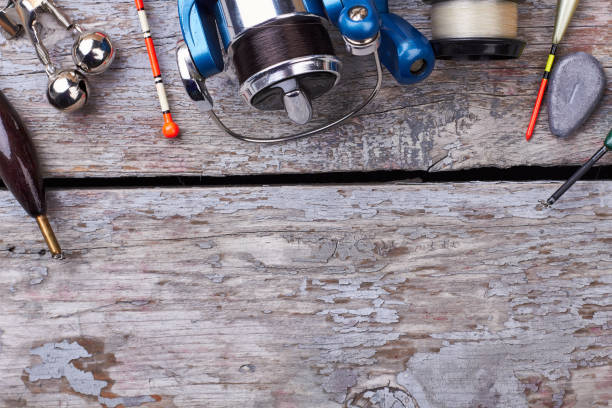 istock Fishing tackle on wooden surface. 638705264