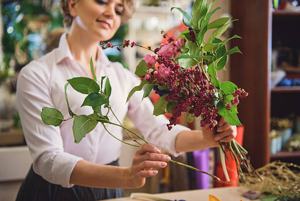 istock Skillful female florist enjoying her work 638709992