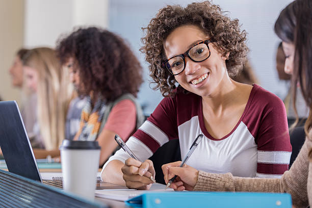istock Beautiful African female college student smiles in class 638711492