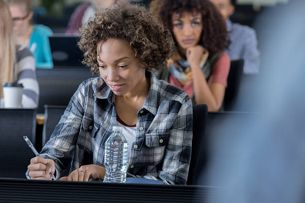 istock Focused female college student takes exam 638711646