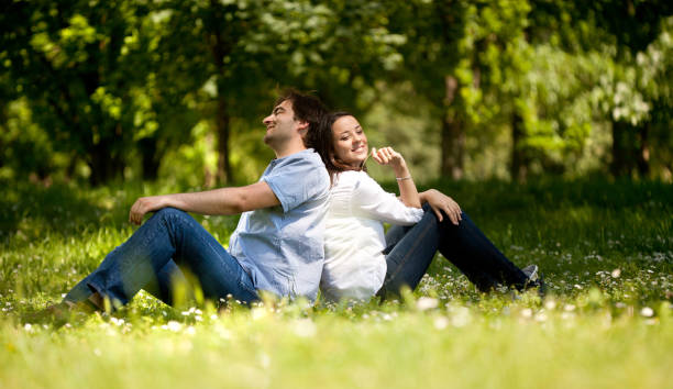 istock Young couple in the park sitting back to back 638714588