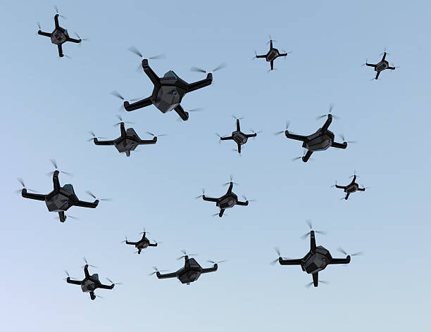 Swarm of drones flying in the sky Swarm of security drones with surveillance camera flying in the sky. 3D rendering image unmanned aerial vehicle stock pictures, royalty-free photos & images