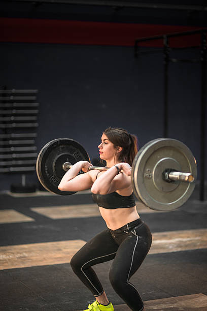 istock woman doing a strong training with the barbell 638715180