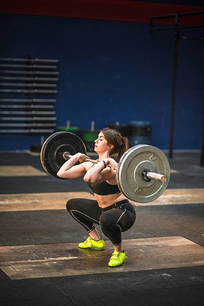 istock woman doing a strong training with the barbell 638715550