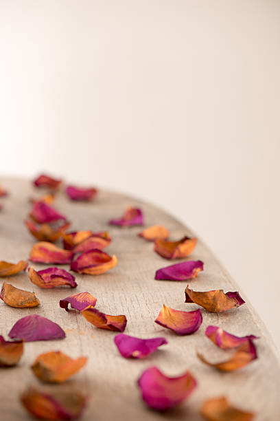 istock Wooden tabletop with rose petals 638716462