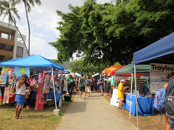 people explore booths that line pathway at earth day - enviromentalism imagens e fotografias de stock