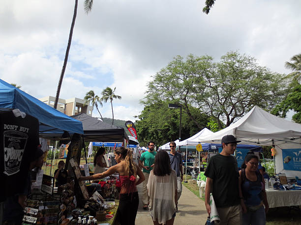 people explore booths that line pathway at earth day - enviromentalism imagens e fotografias de stock