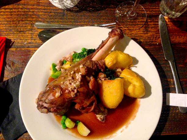 istock Lamb, roast potatoes, vegetables and gravy. Pub food. 638717340