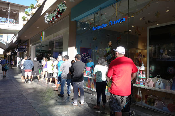People stand in line to get inside Microsoft Windows Honolulu, United States - December 12, 2014: People stand in line to get inside Microsoft Windows Store for big sale in Honolulu at the Ala Moana Center who's technology is in most modern computers on December 12 2014. bill gates stock pictures, royalty-free photos & images