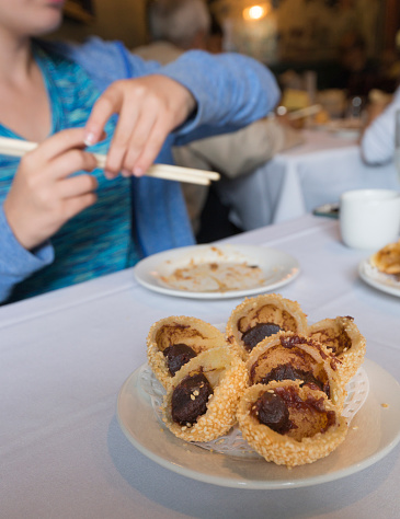 Seseame balls filled with red bean paste, dim sum, Chinese food in a restaurant in Victoria, Vancouver Island, British Columbia, Canada