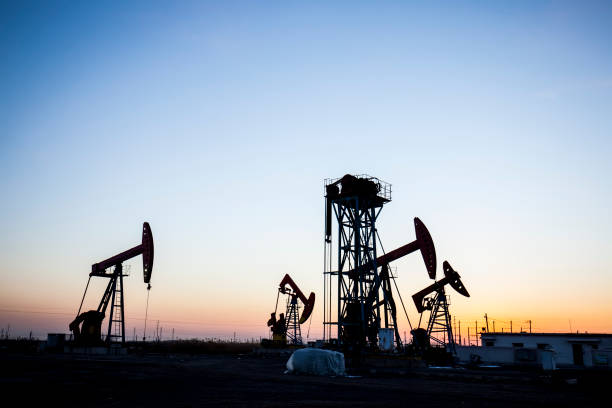 istock the evening of beam pumping unit in silhouette 638719694