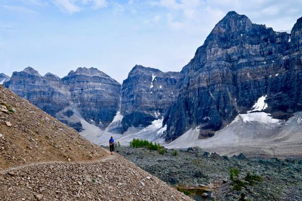 istock Woman hiker walking in rocky mountains. 638721364