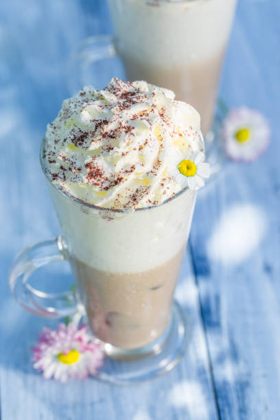 istock Cold latte with cream in sunny garden 638721472