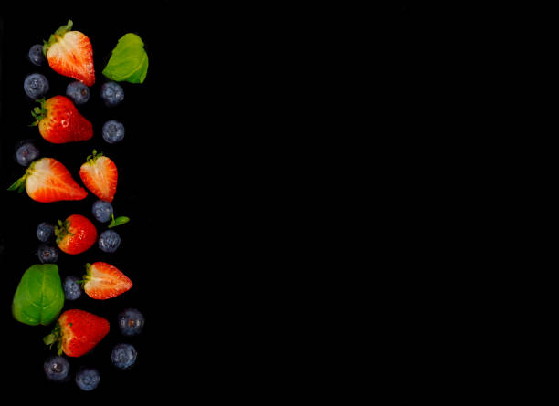istock Strawberries and blueberries on a black background 638721608