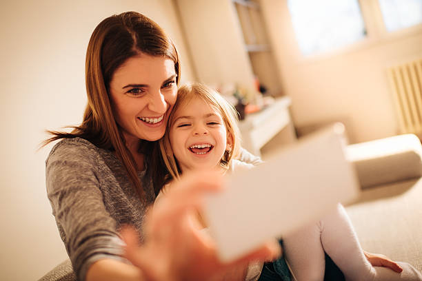 istock Mother and daughter taking selfie 638721972