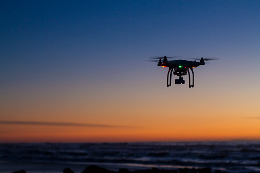 Dron sobrevolando el océano al amanecer photo