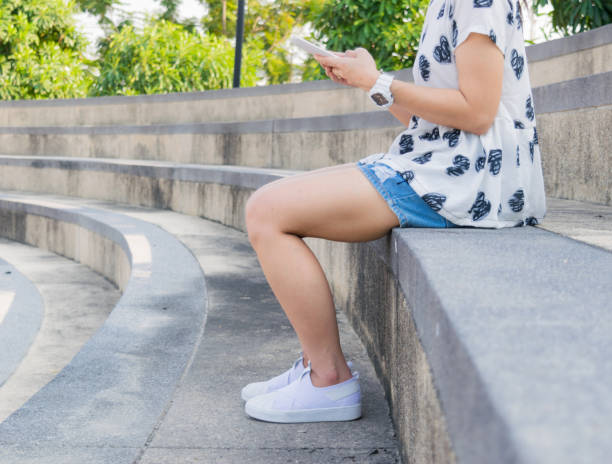 istock Woman legs wearing white shoes 638722826