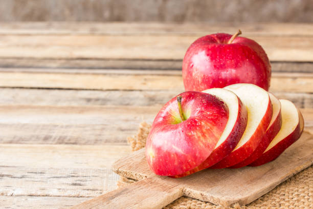 istock Close up of a sliced apple on wooden table. 638724192