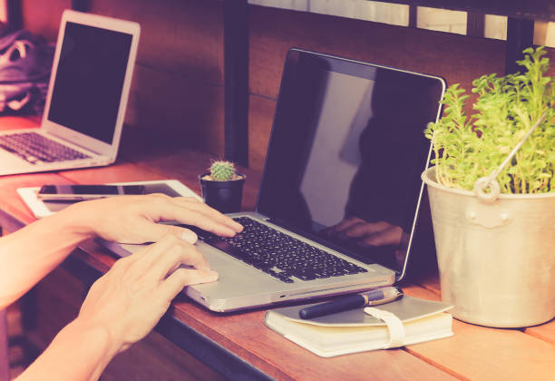 istock Business man hand using laptop on wooden table. 638725184