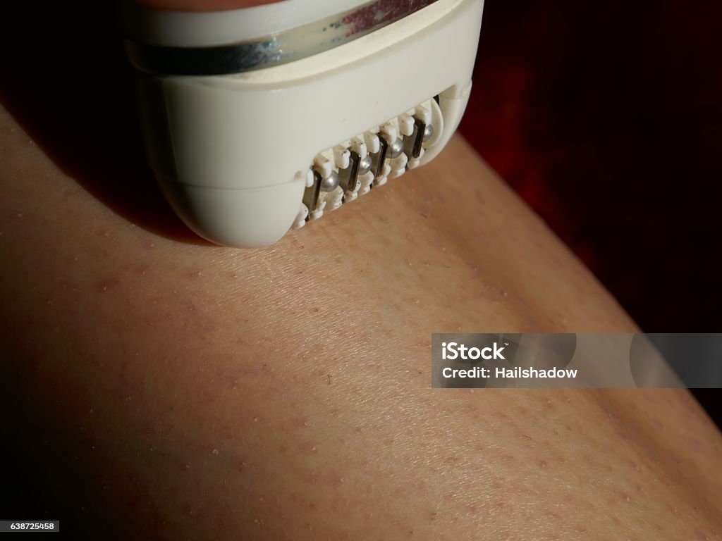 Tweezer epilator Removing hair with mechanical epilator. Women Stock Photo