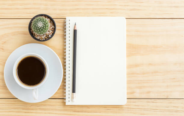 istock Coffee cup, pencil and notebook on wooden table 638725514