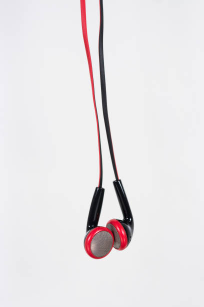 istock ear buds or earphones vertical on white background 638725554