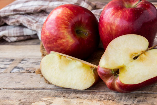 istock Fresh red apple on old wooden table background 638726906