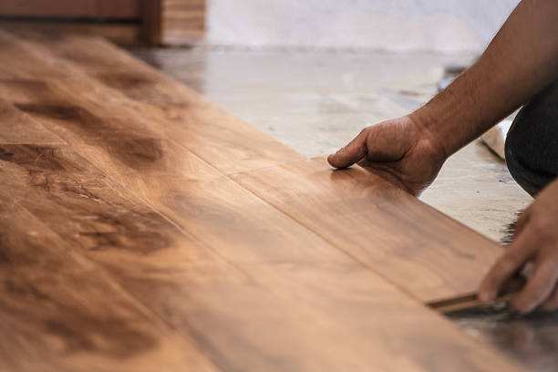 Installing Wood Flooring Man installing wood flooring in home. installing photos stock pictures, royalty-free photos & images