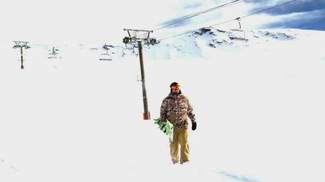 young man with snowboard on winter holiday