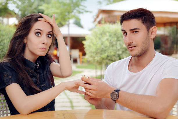 istock Surprised Woman Receiving Engagement Ring from Man 638728836