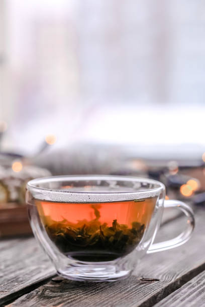 istock Transparent Cup of tea on wooden background 638729152