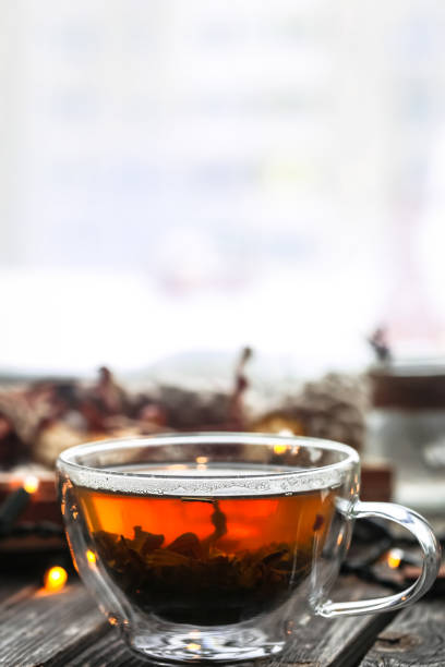 istock Transparent Cup of tea on wooden background 638729162