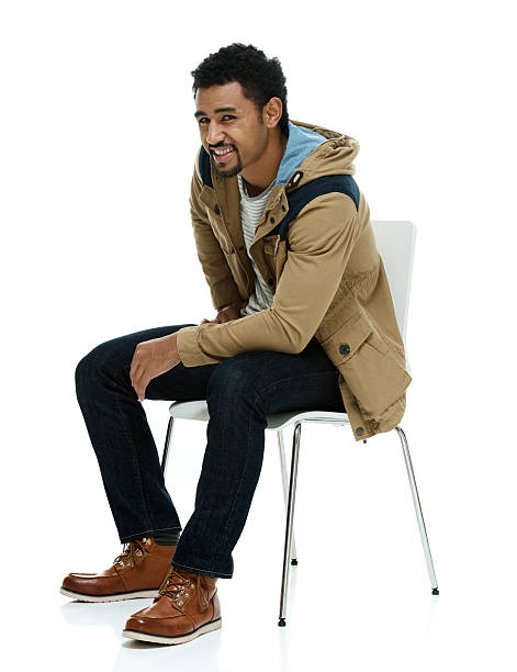 istock Smiling man sitting on chair 638733400