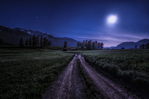 A hiking trail in Mieming illuminated by moonlight.