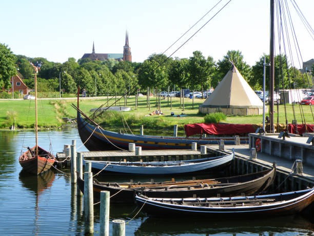 Moored Boats at the Pier and Roskilde City's Famous Landmark St. Luke Cathedral, Roskilde, Denmark